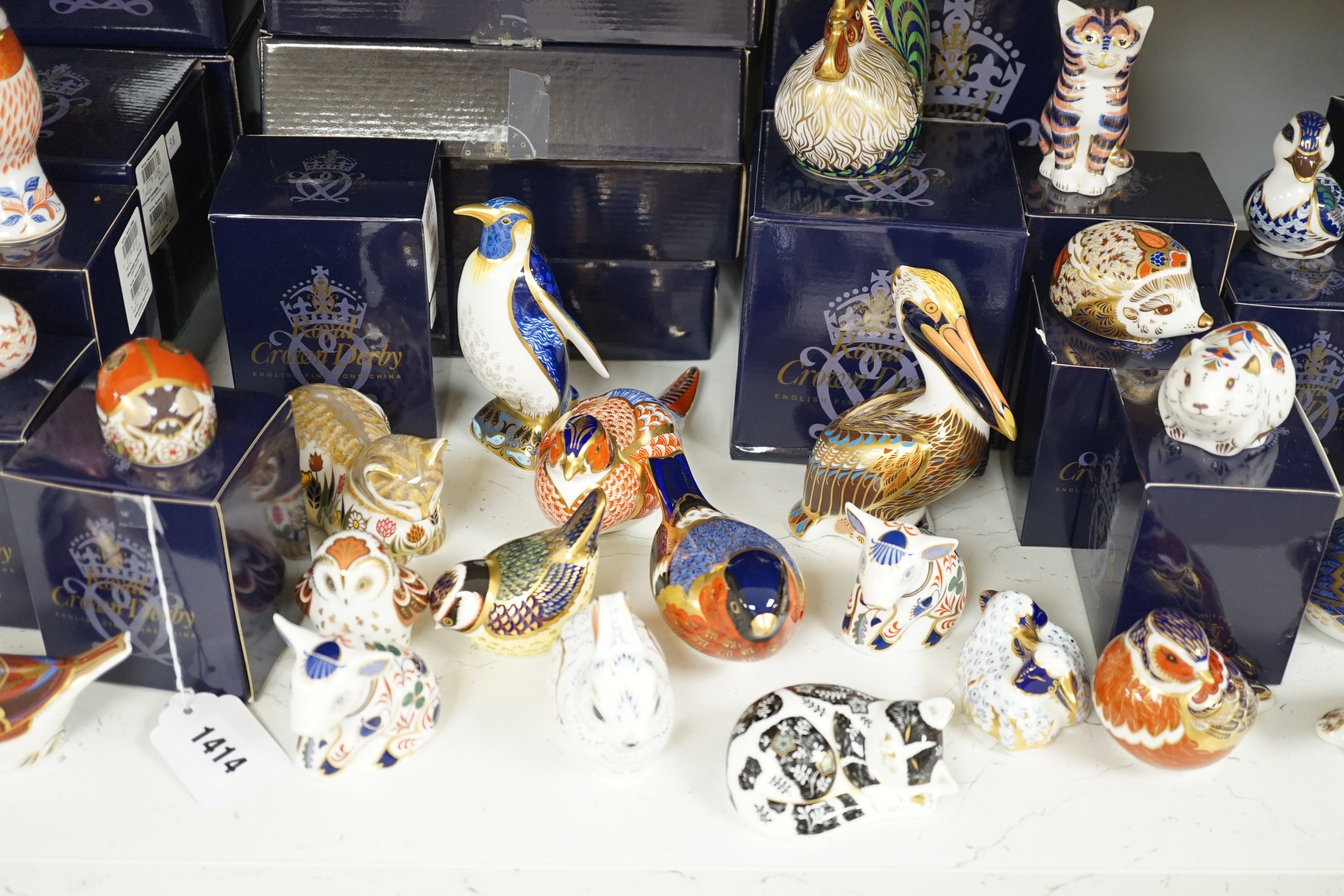 Approximately thirty-two Royal Crown Derby Imari porcelain paperweights, all but two with original boxes and mostly gold bottoms